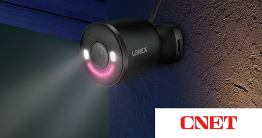 Lorex 4K Wi-Fi Spotlight Camera mounted on an exterior wall at night, displaying its deterrence lights, featured in CNET’s Early Black Friday coverage of home security deals.