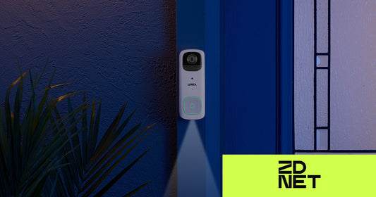 Lorex 2K battery-powered video doorbell mounted beside a front door at night, with a soft spotlight illuminating the ground and ZDNET logo in the corner, featured in an article about switching from Ring to a subscription-free alternative.